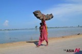 Lone Refugee Woman Walks Along Flooded Area In Pakistan