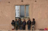 Afghan Children Suffering Poverty Stand Outside A House In Herat Province