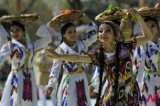 Uzbek women in colorful costumes dance to celebrate Navruz, New Year holiday