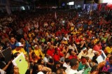 Malaysian people listen to opposition leader’s speech at election campaign