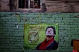 Pakistani opposition leader’s election campaign poster hung on wall