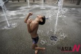 Singaporean Boy Cools Off At Fountain