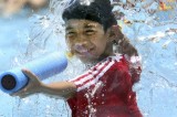 Taiwanese Boy Enjoys Water Splash In Heat