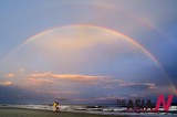 Double Rainbows Over Sea Enchant Beachgoers
