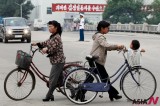 Women On Bicycles In Street Of A NK City