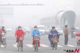 People Rush On Bicycle Amid Dense Fog In Lianyungang, East China