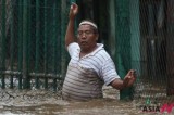 Heavy Rains Force People To wade Through A Flooded Street In Jakarta
