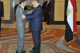 Egyptian President Morsi greets his Iranian counterpart Ahmadinejad in Cairo