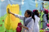 Pakistani arts students take part in a street painting competition in Lahore