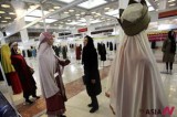 An Iranian woman looks at outfits on mannequins during Int’l Fashion, Clothing Festival