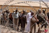 Suspected al-Qaida members led away to detention center in an Iraqi army base