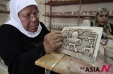 Female Palestinian artists paint on ceramic articles at a factory in Nablus, West Bank