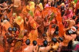 Hindu devotees stage Huranga game between men and women at a temple near Mathura, India