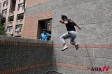 A young man practices parkour at Taiwan University campus