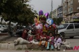 A Pakistani woman and children sell balloons in Islamabad