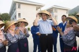 Chinese President Xi puts on traditional bamboo hat in Hainan Province
