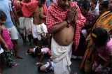 Indian children lie on the ground as a ritual for Hindu festival