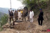 Pakistani soldiers inspect blast site dug up by terrorists’ attack