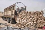 A worker unloads salt blocks from truck in northern Afghanistan