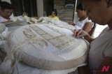 Filipino women perform traditional hand embroidery on pineapple fabric