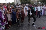 An Indian Charlie Chaplin impersonator performs in front of tourists