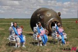 Chinese astronauts wave hands after successfully ending space mission
