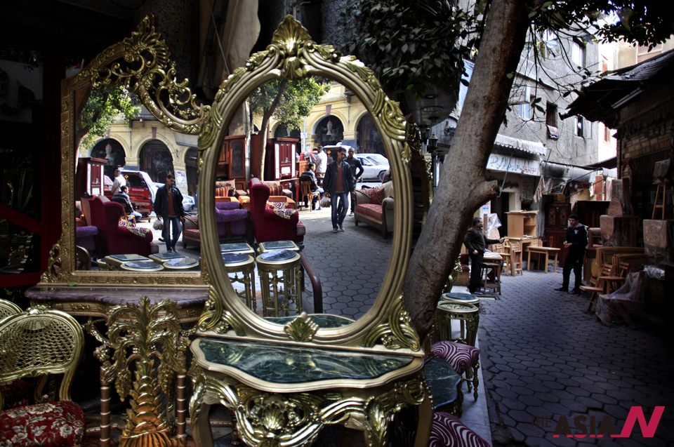 Egyptians Walking In A Street Seen Reflected In Mirrors Of