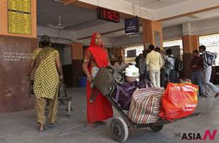 An Indian woman works as porter, a man’s job, at Bhavnagar railway station