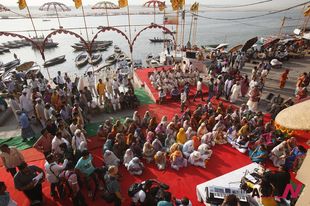 Elderly Indian widows pray on bank of Ganga river