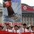 In this June 25, 2013 photo, North Koreans chant slogans on Kim Il Sung Square in Pyongyang, North Korea as they hold an anti-U.S. demonstration during the 63rd anniversary of the outbreak of the three-year Korean War, from 1950 to 1953. The poster reads "Meet Force with Force," top, "National Missile Defense System. A Strong Stand," center, and "Meet Hardliners with Harder Attitudes," bottom. (AP Photo/Jon Chol Jin)