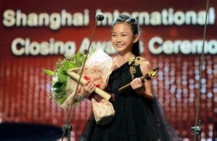 Crystal proudly showing off the award she won as Best Actress in Shanghai International Film Festival