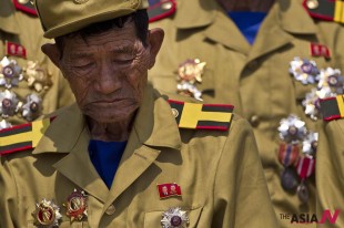 A North Korean veteran of the Korean War bows his head during a mass military parade on Kim Il Sung Square in Pyongyang to mark the 60th anniversary of the Korean War armistice, Saturday, July 27, 2013. (AP Photo/David Guttenfelder)