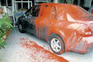 Splashing red paint as a sign of warning to pay up
