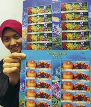 The head of Pos Malaysia Stamp and Philatelic Division, Yasmin Ramli showing the new issued colorful stamps “Living Corals in Malaysia”