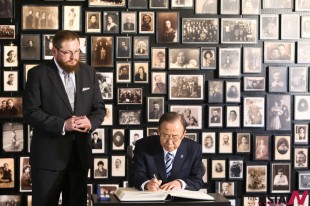 Secretary-General of the United Nations Ban Ki-moon (R) makes an inscription in the Memorial guestbook as he visits the former Auschwitz concentration camp in Auschwitz, Poland, on Nov. 18, 2013. (Xinhua/NEWSis)
