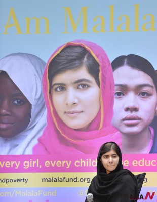Malala Yousafzai stands against the backdrop of her memoir titled I am Malala at an International Day of the Girl event at World Bank headquarters in Washington D.C., the United States, Oct. 11, 2013. (Photo : Xinhua/NEWSis)