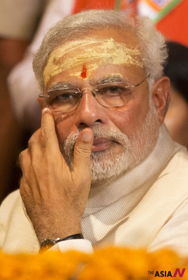 Hindu nationalist Bharatiya Janata Party leader and India’s next prime minister Narendra Modi watches evening rituals being performed on the banks of the River Ganges in Varanasi, an ancient city revered by millions of devout Hindus, India, Saturday, May 17, 2014. (Photo : AP/NEWSis)