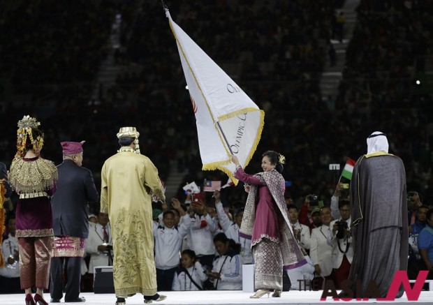 President of Olympic Council of Asia Sheikh Ahmad Al Fahad Al Sabah, right, watches Rita Subowo, President of the National Olympic Committee of Indonesia, wave the Olympic Council of Asia flag during the closing ceremony for the 17th Asian Games in Incheon, South Korea, Saturday, Oct. 4, 2014. (Photo : AP/NEWSis)