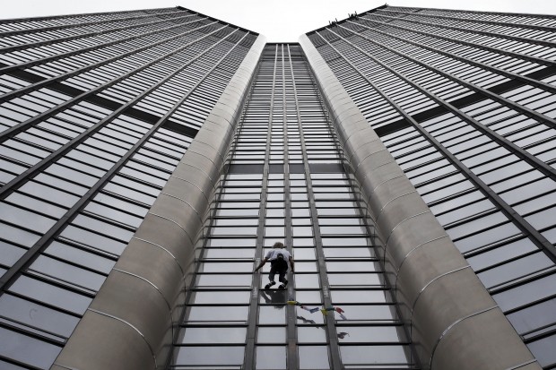 April 28, 2015 photo from files showing Alain Robert, also known as the French Spiderman, climbing the Montparnasse tower a 210-metre (689 ft) office skyscraper located in the Montparnasse area of Paris, France. Robert decided to climb in solidarity with the victims of the Saturday's earthquake in Nepal. (AP Photo)