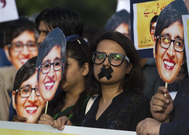  Supporters of prominent women's rights activist Sabeen Mahmud, who was killed by unknown gunmen, hold her pictures during a rally, Tuesday, April 28, 2015, in Islamabad, Pakistan. Gunmen on a motorcycle killed Mahmud last Friday in Pakistan just hours after she held a forum on the country's restive Baluchistan region, home to a long-running insurgency, police said. (AP Photo)