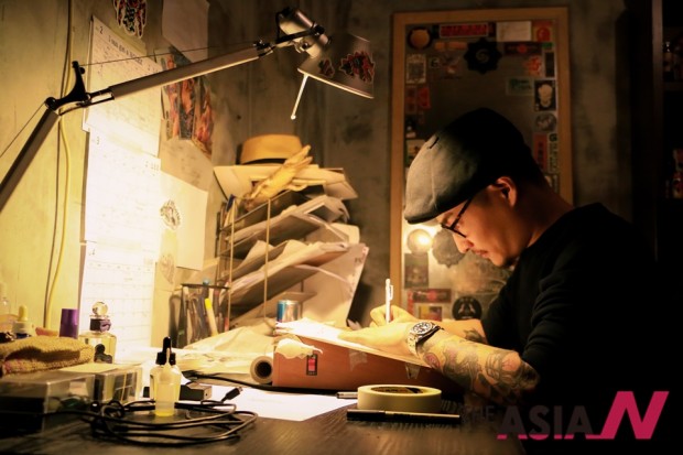 Tattoo artist Kay Lee practicing his skills at Hybrid Ink Tattoo studio.
