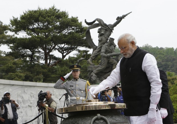 Indian Prime Minister Narendra Modi, right, burns incense at the National Cemetery in Seoul, South Korea, Monday, May 18, 2015. Modi arrived Monday for a two-day visit to meet with South Korean President Park Geun-hye and to discuss economic ties and boost bilateral cooperation. (AP Photo)