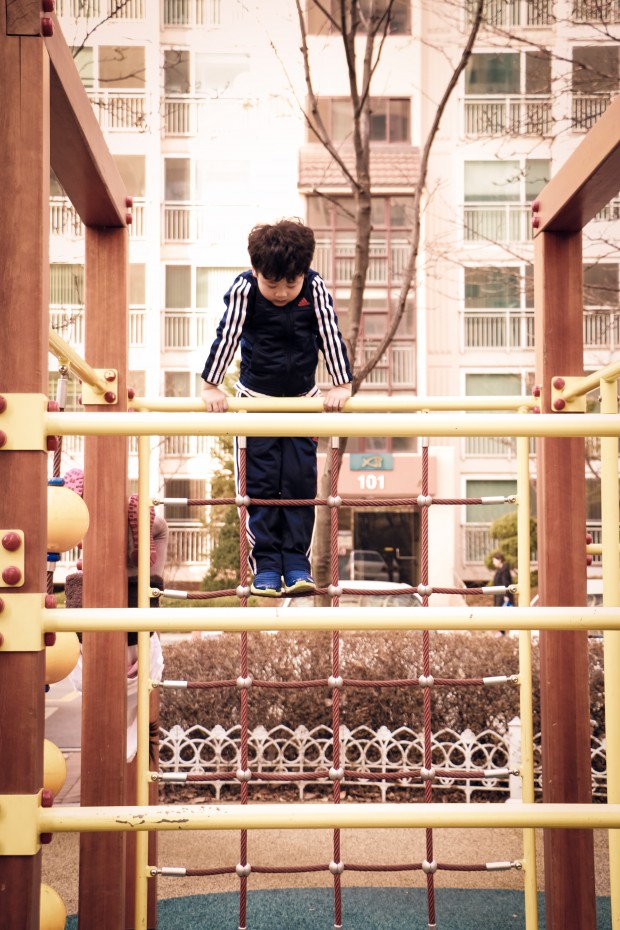 A kid lost in play in a park in Mullae, Seoul.