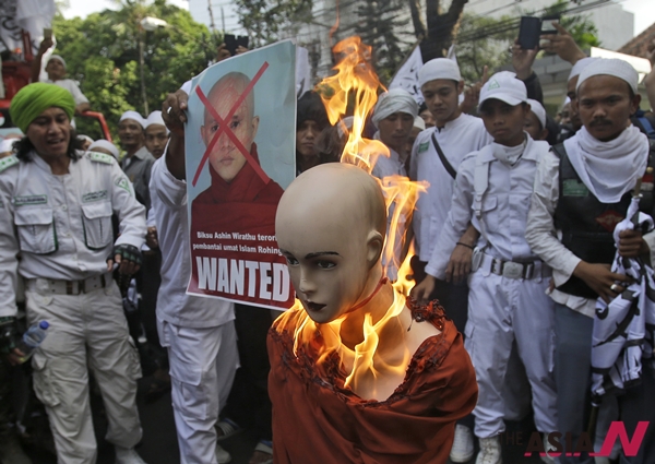 Indonesian Muslim protesters burn a mannequin representing Myanmar's radical Buddhist monk Ashin Wirathu during a protest demanding an end to the violence against ethnic Rohingyas in Rakhine State, outside the Embassy of Myanmar in Jakarta, Indonesia, Wednesday, May 27, 2015. In the last three years, hundreds of minority Rohingya Muslims have been killed and hundreds of thousands others others are now living under apartheid-like conditions in crowded camps or forced to flee their homes to avoid persecution in Buddhist-majority Myanmar.