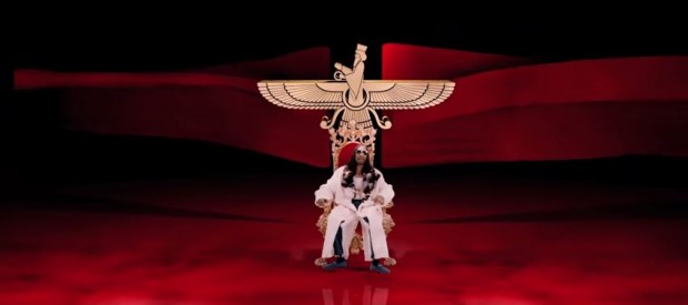 In this still from the video, Snoop smokes a blunt, sitting on a throne under a gold Faravahar, the most sacred symbol of the Zoroastrian religion and an image frequently associated with Persian history. This imagery enraged Indian Zoroastrians, leading them to file a complaint in the high court.