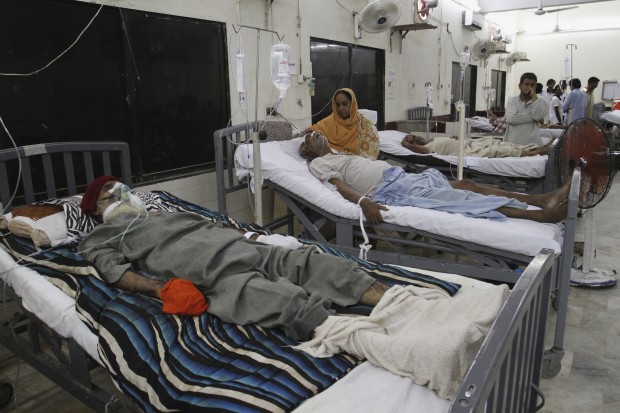 People visit those suffering from heatstroke and dehydration admitted at a local hospital in Karachi, Pakistan, Monday, June 29, 2015. (AP Photo)