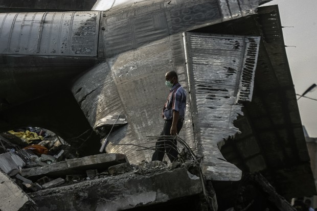 A security member works at the crash site of an Indonesian military plane in the North Sumatra city of Medan, Indonesia, July 1, 2015. (Xinhua)