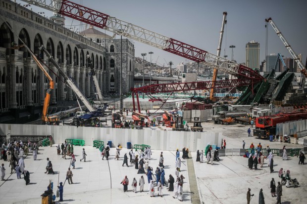 Muslim Pilgrims walk past the site of a crane collapse that killed over a hundred Friday at the Grand Mosque in the holy city of Mecca, Saudi Arabia. (AP Photo/Mosa'ab Elshamy) 