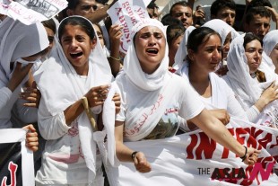 Yazidi Kurdish women chant slogans during a protest against the Islamic State group's invasion on Sinjar city one year ago, in Dohuk, northern Iraq, Monday, Aug. 3, 2015. Thousands of Yazidi Kurdish women and girls have been sold into sexual slavery and forced to marry Islamic State militants, according to Human Rights organizations, Yazidi activists and observers. (AP Photo/Seivan M.Salim)