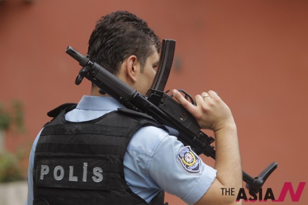 An armed Turkish police officers have doubled their efforts lately.  (AP Photo/Lefteris Pitarakis) 